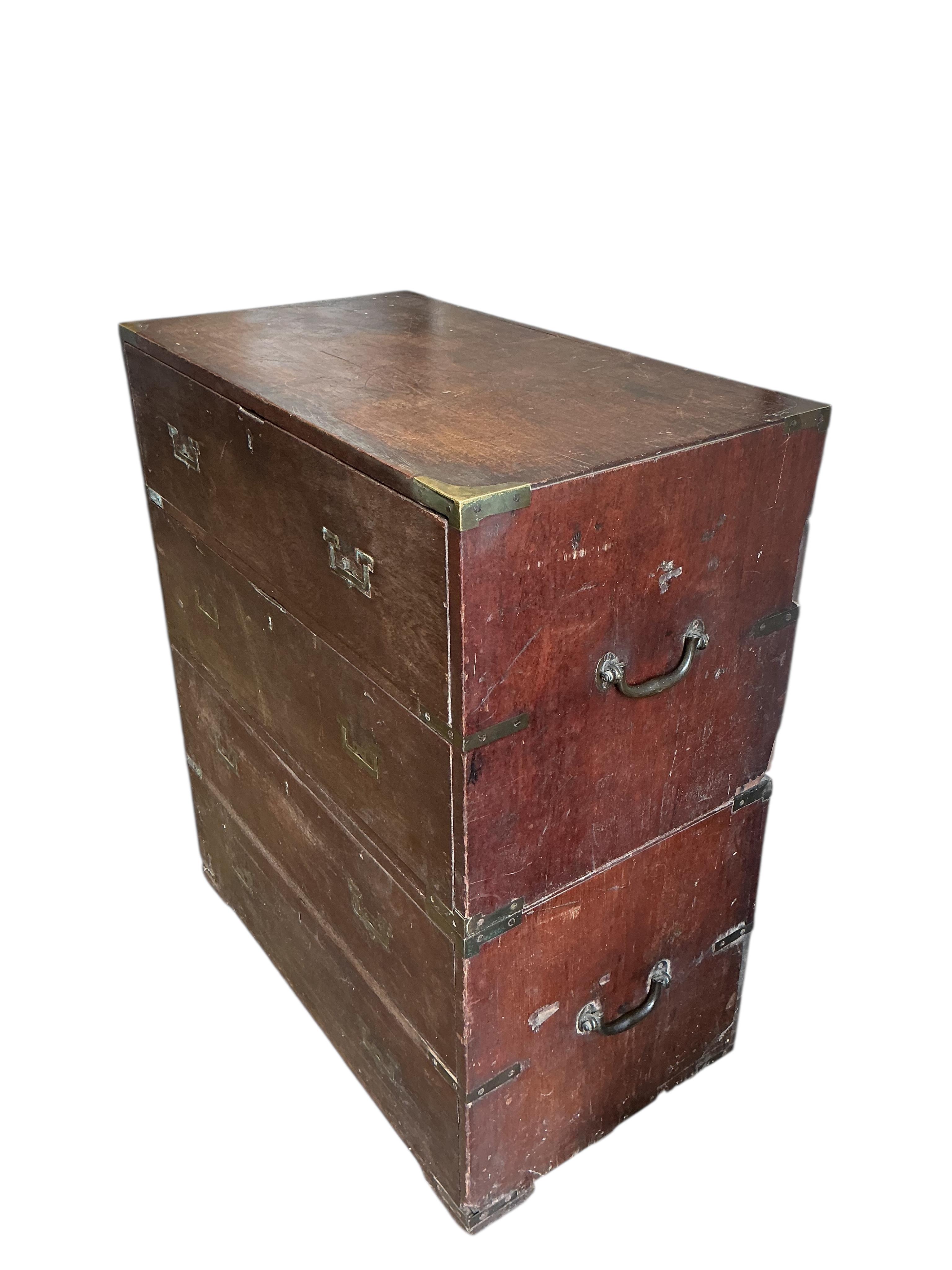 A small early 19th century teak two part campaign chest, the back with stencilled name, Mrs Nepean, width 81cm, depth 46cm, height 95cm
